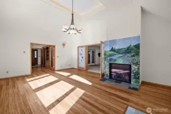 Bright and Inviting Living Room Highlighted by Vaulted Ceilings and Custom Fireplace and hardwood flooring.