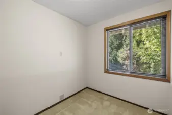 Small reading room or flex room with window offering natural light and a closet for storage