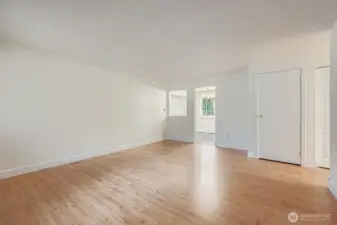 Formal living area with solid wood shutters, engineered hardwood floors and fresh paint.
