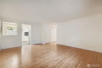 Light and bright formal living area with solid wood shutters, engineered hardwood floors and fresh paint.