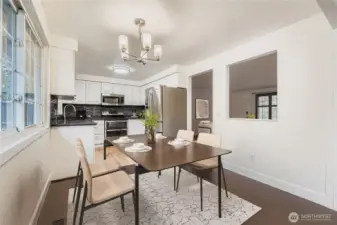 Virtually staged. Dining area off updated kitchen features engineered hardwoods and new lighting fixture. Space can accommodate up seating for up to 6.