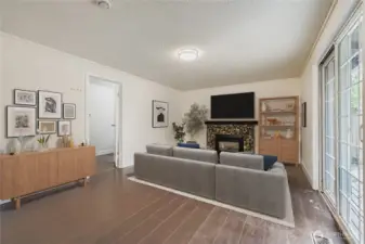 Virtuallly staged. Family room with gas fireplace, engineered hardwoods, fresh paint and slider to BBQ deck and huge backyard. Adjacent laundry room and 1/2 bath combo.