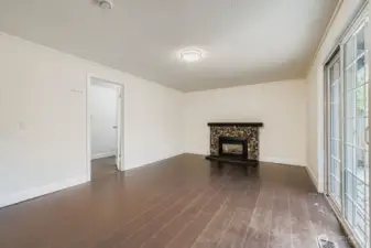 Family room with gas fireplace, engineered hardwoods, fresh paint and slider to BBQ deck and huge backyard. Adjacent laundry room and 1/2 bath combo.