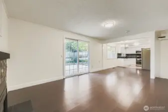 Family room with gas fireplace, engineered hardwoods, fresh paint and slider to BBQ deck and huge backyard. Adjacent laundry room and 1/2 bath combo.