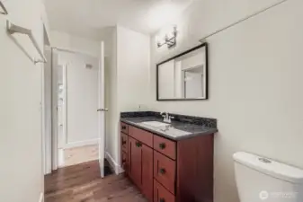 Full bath with shower/tub combo, granite counters and fresh paint.