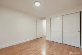 2nd bedroom with large closet, fresh paint, all new lighting and engineered hardwoods.