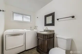 1/2 bath and laundry room. Washer and dryer stay.