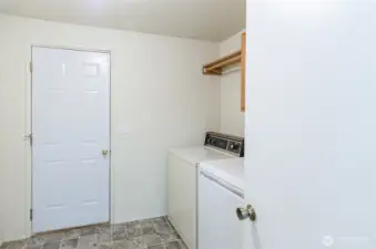 Ample utility room with large closet on opposite wall.  Door leads to oversized garage.