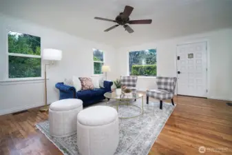 Bright and welcoming living room with abundant natural light and plenty of space for gathering.