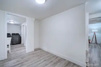 Flexible downstairs room that could easily serve as part of a private lower-level unit.