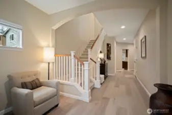 Welcoming foyer with new luxury French oak wide-plank flooring.