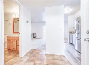 Entryway to the right.  Enters into hallway between kitchen, living room & bathroom.