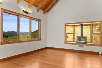 Living room with propane heat, bay window and Northern views of the mountains.