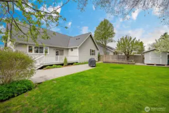 Well maintained yard, fenced, garden area, fruit trees and shed