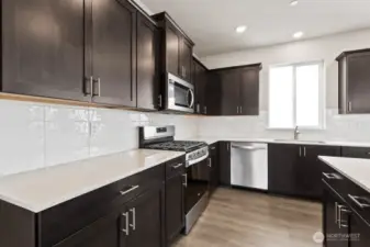Gas cooktop and stainless-steel appliances; Colors, finishes, and options will vary.