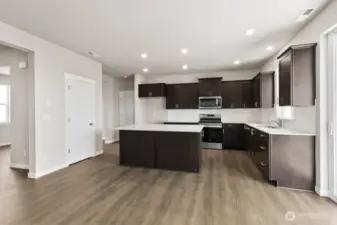 View from Great Room into kitchen; Colors, finishes, and options will vary.