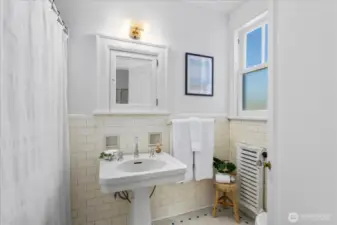 The bathroom has original tile flooring.
