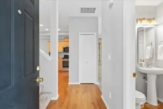 Entry with oak hardwoods. Neutral gray walls throughout.