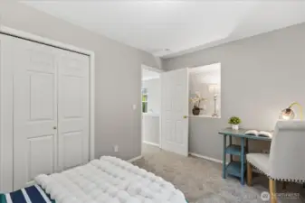2nd bedroom with storage nook behind the door.