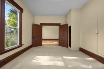 French doors lead into the primary bedroom from the living room.