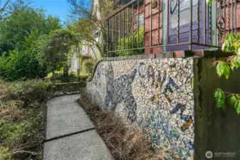 The artist owner added many whimsical touches to this lively cottage, including this mosaic of a dog which reads "Cave Canem," Latin for "Beware of Dog."