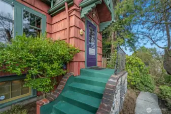 Above the entry, notice the bracketed cornice with decorative corbels. This, and the textured wood siding are indicative of the architectural style.