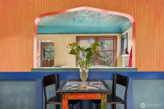 The arched pass-through between the kitchen and living room elegantly joins the spaces.