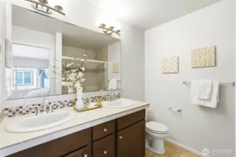 Primary bathroom boasts double sinks and large shower.