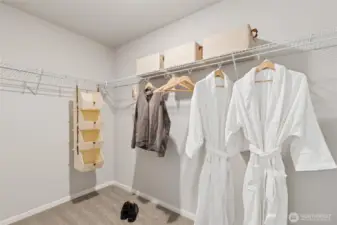 Huge walk-in closet in primary suite. Photo is representational. Actual home is under construction. Colors, materials, and features may vary. See site agent for details.