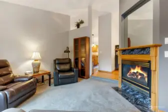 Cozy living room/sitting area as you enter home. Gas fireplace with beautiful surround for those cozy days and nights