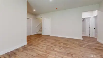 Lower Level Family  Room area with 2 Bedrooms to Right and Office Room and No Closet Straight ahead, Stairs to Main Level, Full Bathroom w/ Heated Floors to finish description also Door to Huge Garage!!
