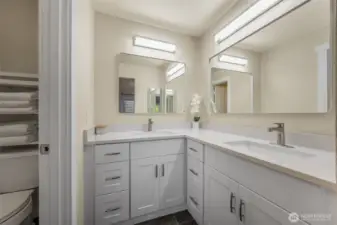 The primary bathroom was just updated with a new double vanity, quartz counters, and modern lighting