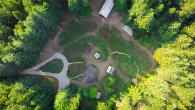 Aerial of the meadow, barn, original farmhouse, sleeping cabin, potting shed and woodshed.