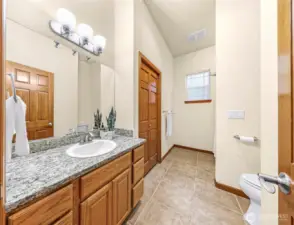 Guest bathroom with large storage closet and bathtub/shower.