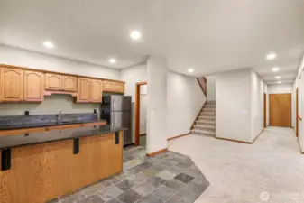 The hallway to the right has a large bedroom, a big storage room and then through the door at the end of the hallway is an unfinished space and another deck.