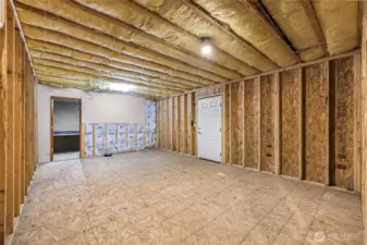 The white door goes out to another large deck. The room straight ahead has a built-in desk and is finished.