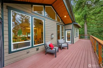 Main floor deck goes around the home to the garage.