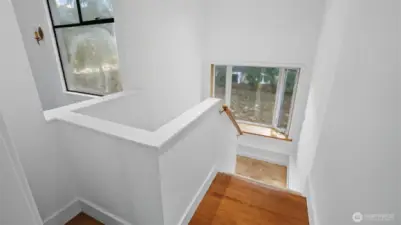 Staircase that leads to 2 bedrooms and utility room.