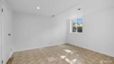 One of two full-height bedrooms downstairs. Notice the large window well for proper egress.