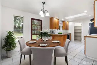 Cute kitchen with surprisingly great storage, including a walk-in pantry. Space for a dining table and bar seating. (Virtual staging)