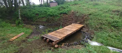 bridge made from trees from the property