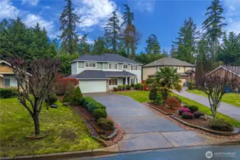 Manicured lawn and thoughtful landscaping frame the home perfectly.