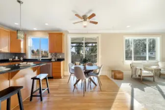 Central open kitchen with informal dining area and bar seating