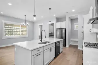The kitchen features gorgeous granite counters, modern wood cabinetry, and a full suite of black stainless steel KitchenAid appliances!