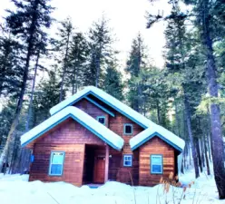 Bearpaw cabin hugs snow framed with Tall Pine tree setting for a super Winter getaway! Ideally located to Trail system for nearby access to Ski Trail system.  Ski from your door.  Legal overnight rental property for several years. Bearpaw cabin is a classic craftsman style home. Investment vacation property at its best!