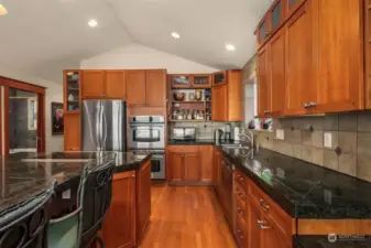 Rich cabinetry and hardwood floors complement the granite countertops.