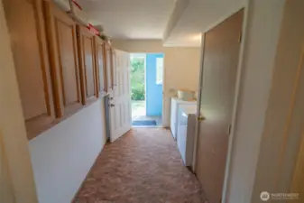 Laundry room with door outside.