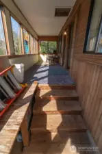 Steps inside the front door to the main home, leading to the sun room.
