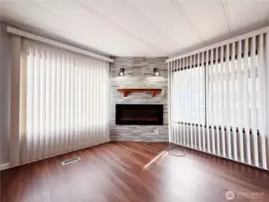 Living Room off of kitchen and entry with heat producing electric fireplace