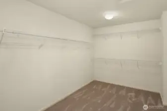 Spacious walk-in closet off primary bathroom.